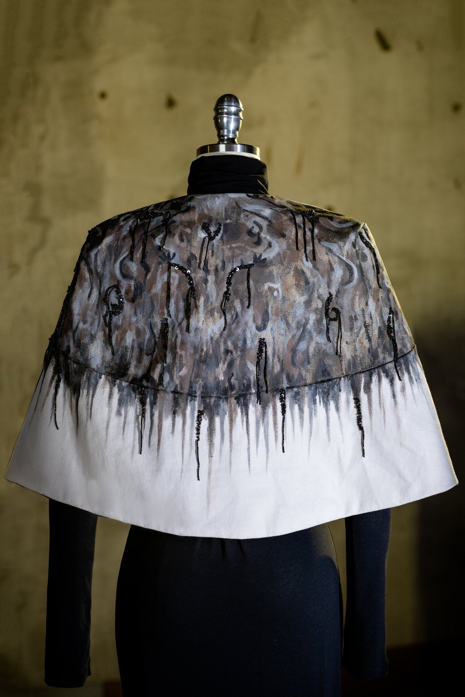 Detail of the hand-painted drip motif, worked across the shoulder by hand